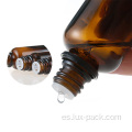 Botella de vidrio de aceite esencial de color ámbar con manipulación